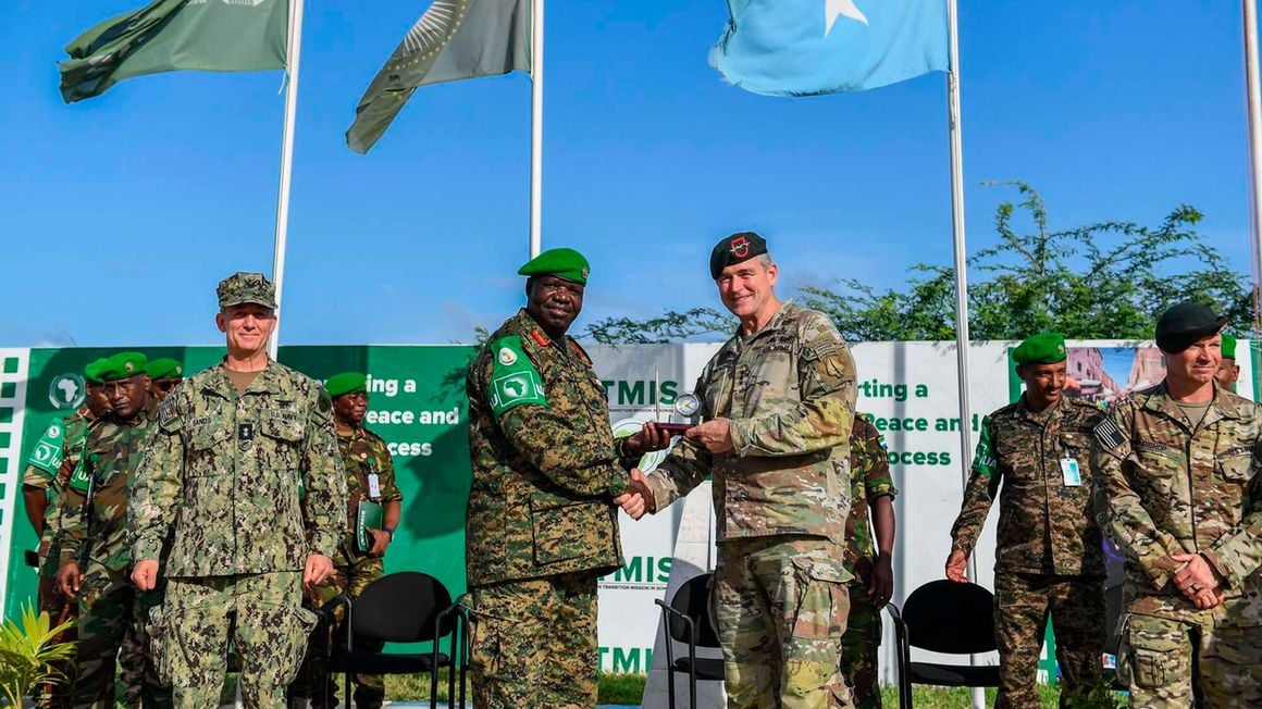Atmis Force Commander Lt. Gen. Sam Okiding shakes hands with Commander of the US Army Special Operations Command and Rear Admiral Jamie Sands at Atmis force headquarters in the Somali capital, Mogadishu on Jube