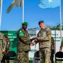 Atmis Force Commander Lt. Gen. Sam Okiding shakes hands with Commander of the US Army Special Operations Command and Rear Admiral Jamie Sands at Atmis force headquarters in the Somali capital, Mogadishu on Jube
